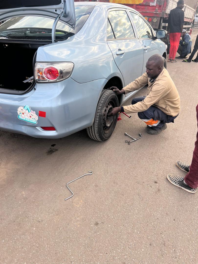 Technician checking a vehicle's tyre